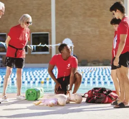 Group of lifeguards learning how to do CPR