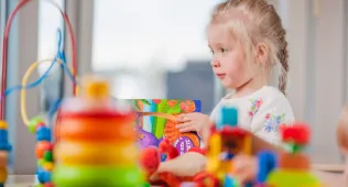 Little girl playing with toys.