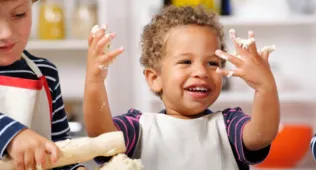 Little boy with dough on his hands
