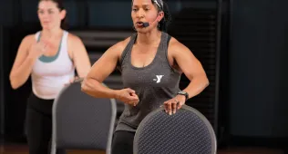 Woman teaching barre with chair