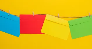 Colorful envelopes hanging on a twine string