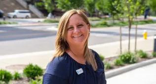 AnnMarie smiling in a navy top
