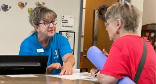 Front desk staff helping a member