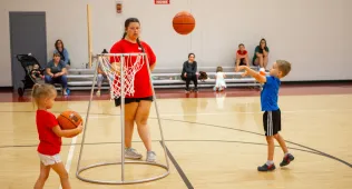 Small child shooting a basketball
