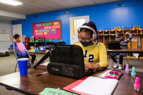 girl with headphones at computer