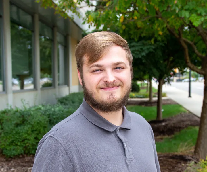 Alex in a grey shirt