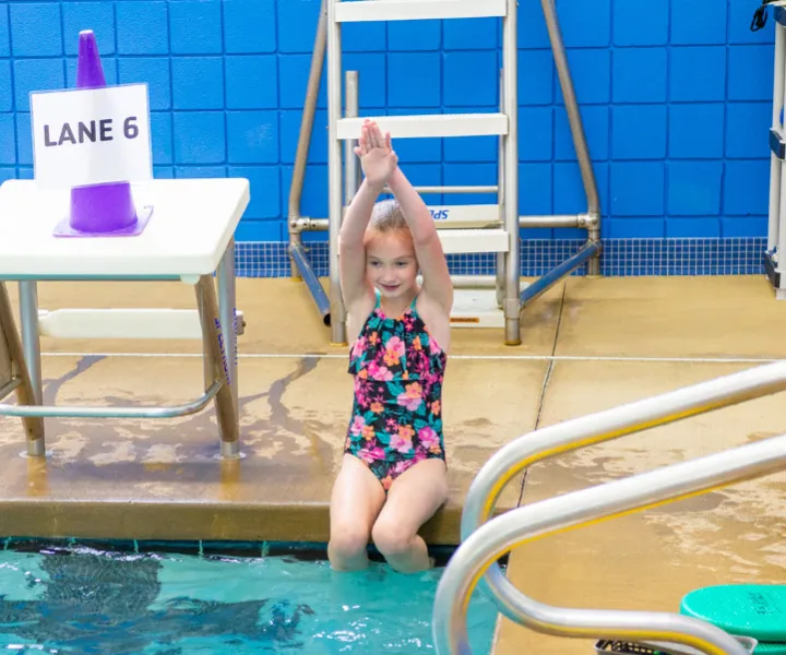 Swimmer ready for a dive into a pool