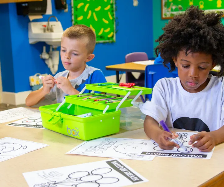 Two campers doing a craft