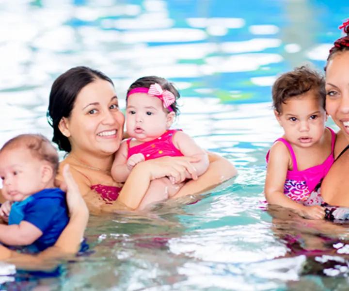 group of moms with babies at a swim lesson