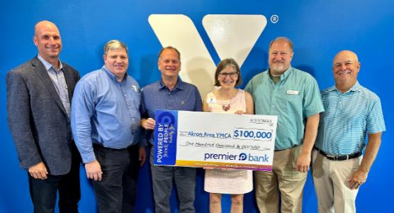 Group of Y Staff holding a check from Premier Bank