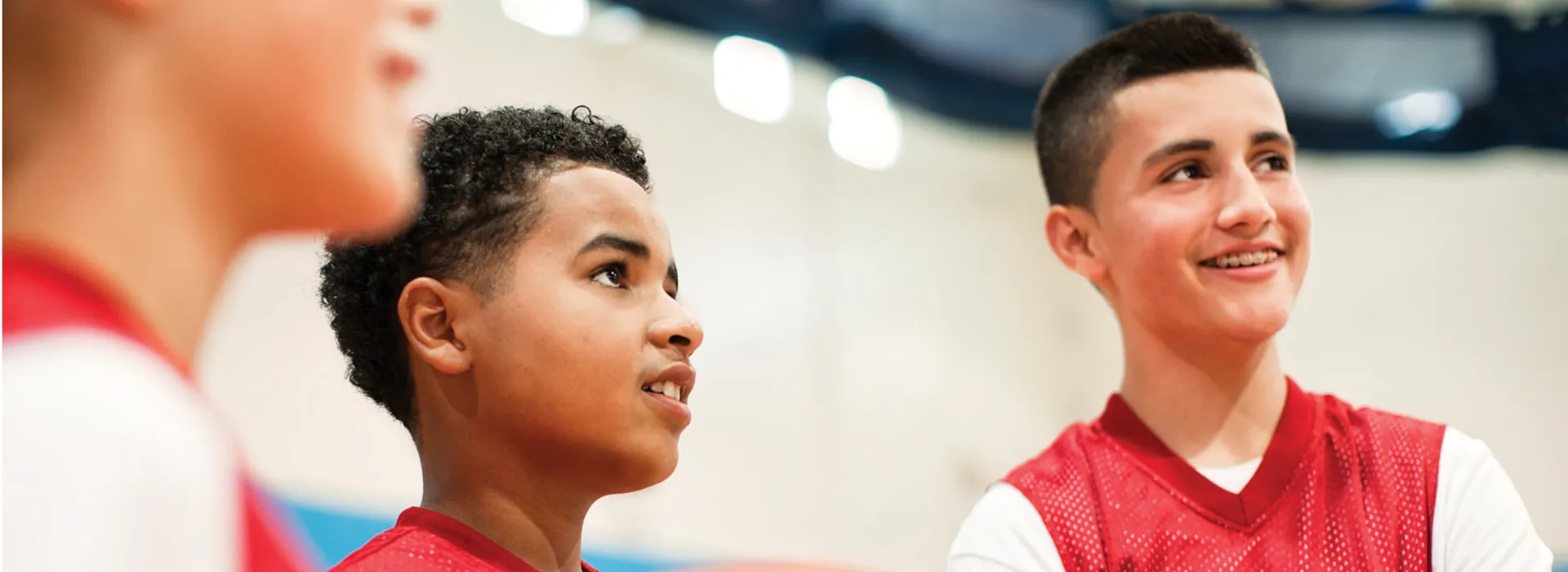 two boys in red Y jerseys looking to the right