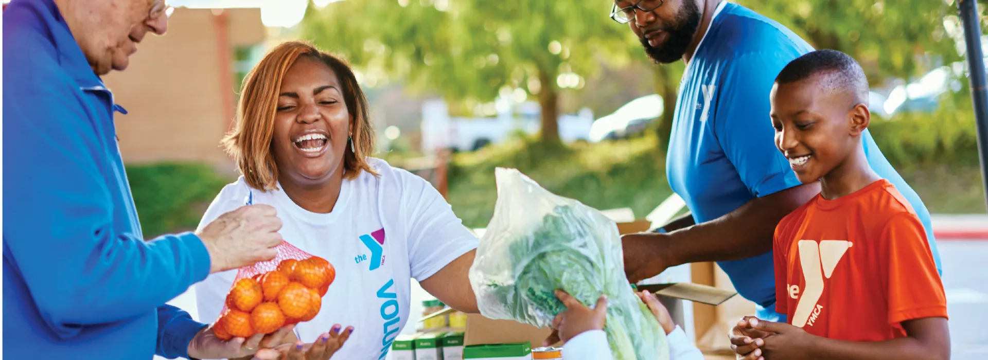 Woman passing out food at a food drive